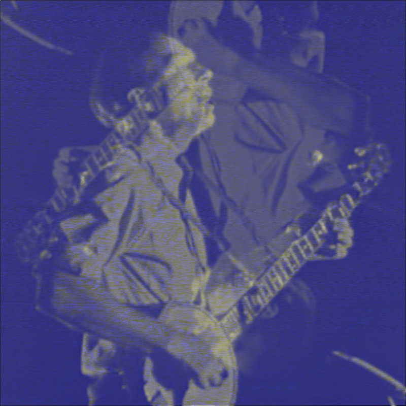 A full-image blue rendering — the echo and midpoint channel operations have cast the entire photograph in deep indigo and cobalt blue. The underlying image shows a man playing an electric guitar, body angled back with the neck raised upward, performing with audience members behind him. Faint yellow-gold details emerge through the blue suggesting stage lighting, and the guitar's frets and tuning pegs are faintly visible.