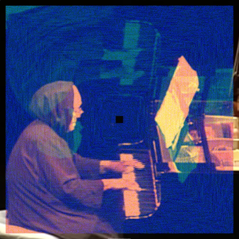 A small, intimate image of an elderly woman seated at a grand piano, shown in profile facing right with her hands on the keys and sheet music on the stand. The room is very dark. Subtle patches of teal and blue-green distortion appear in the upper left of the frame, slightly shifting the ambient cool darkness of the room. The effect is restrained, preserving much of the original image's quiet atmosphere.